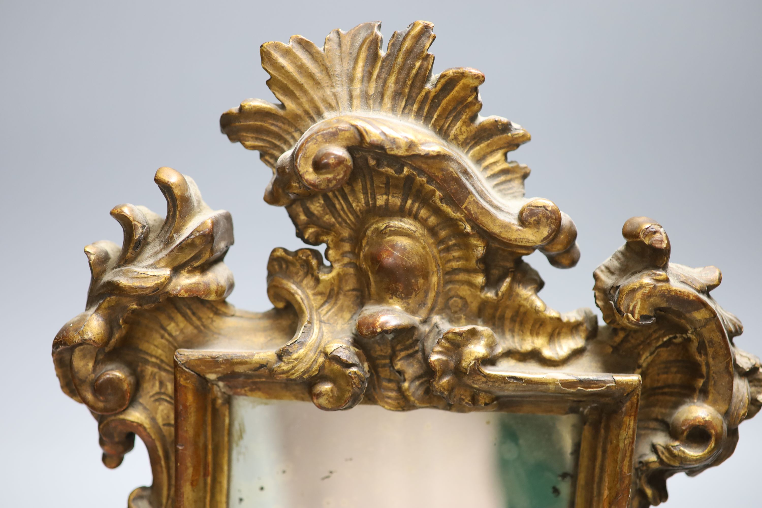 A small 18th century Italian carved giltwood mirror, overall length 38cm